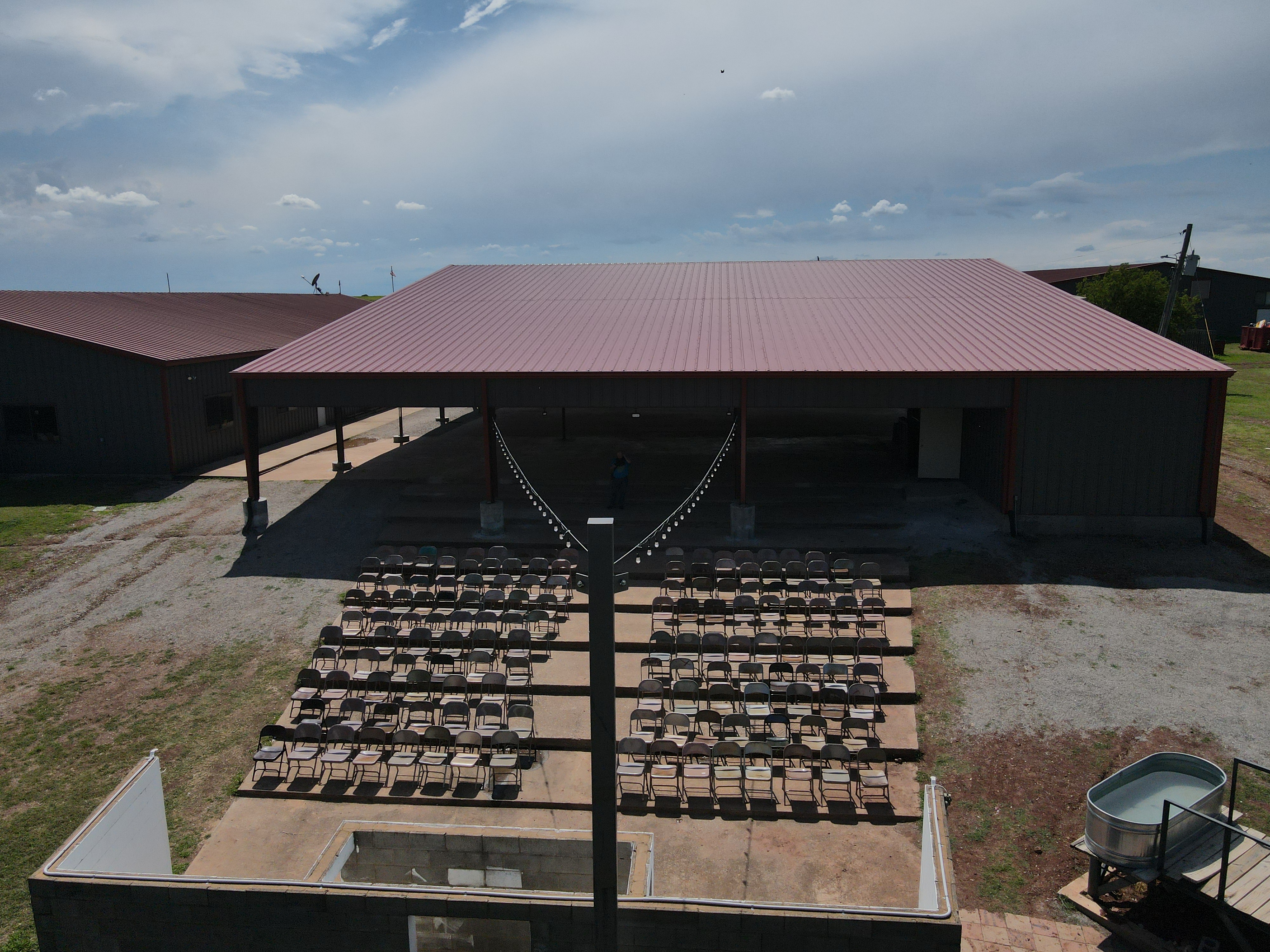 Large wooden pavilion structure in a forest setting